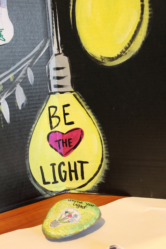 a drawing of a light bulb with the words be the light on it