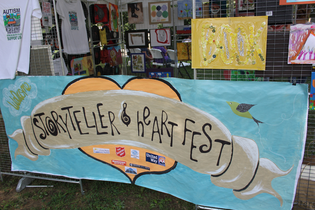 a banner for a festival is displayed in front of a fence