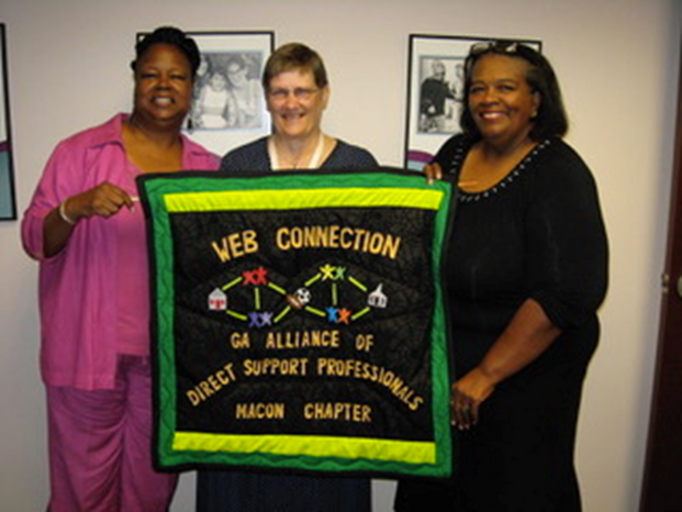 (Georgia DSP Alliance ) three individuals holding up a quilted banner that says web connection